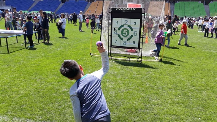 어린이날, 주경기장 개방 행사에서 한 어린이가 후크볼 체험을 하며 공을 던지고 있다.